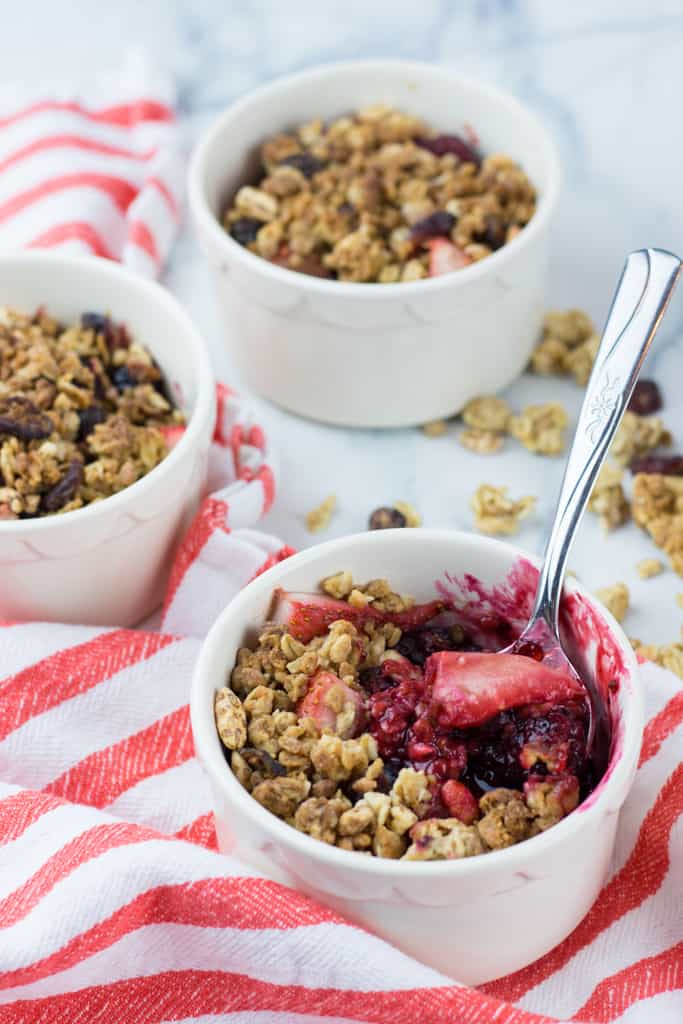 Healthy Triple Berry Crisp recipe baked in individual ramekins is a perfect treat for your friends and family. This easy to make, no-refined sugar, no-butter dessert will become your new favorite!