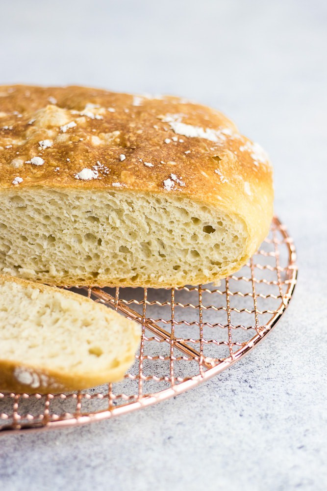 No-knead bread baked in a dutch oven is the easiest bread recipe you can find. Made with only 4 ingredients, this bread is perfectly soft and airy inside and has a beautiful outside crust.