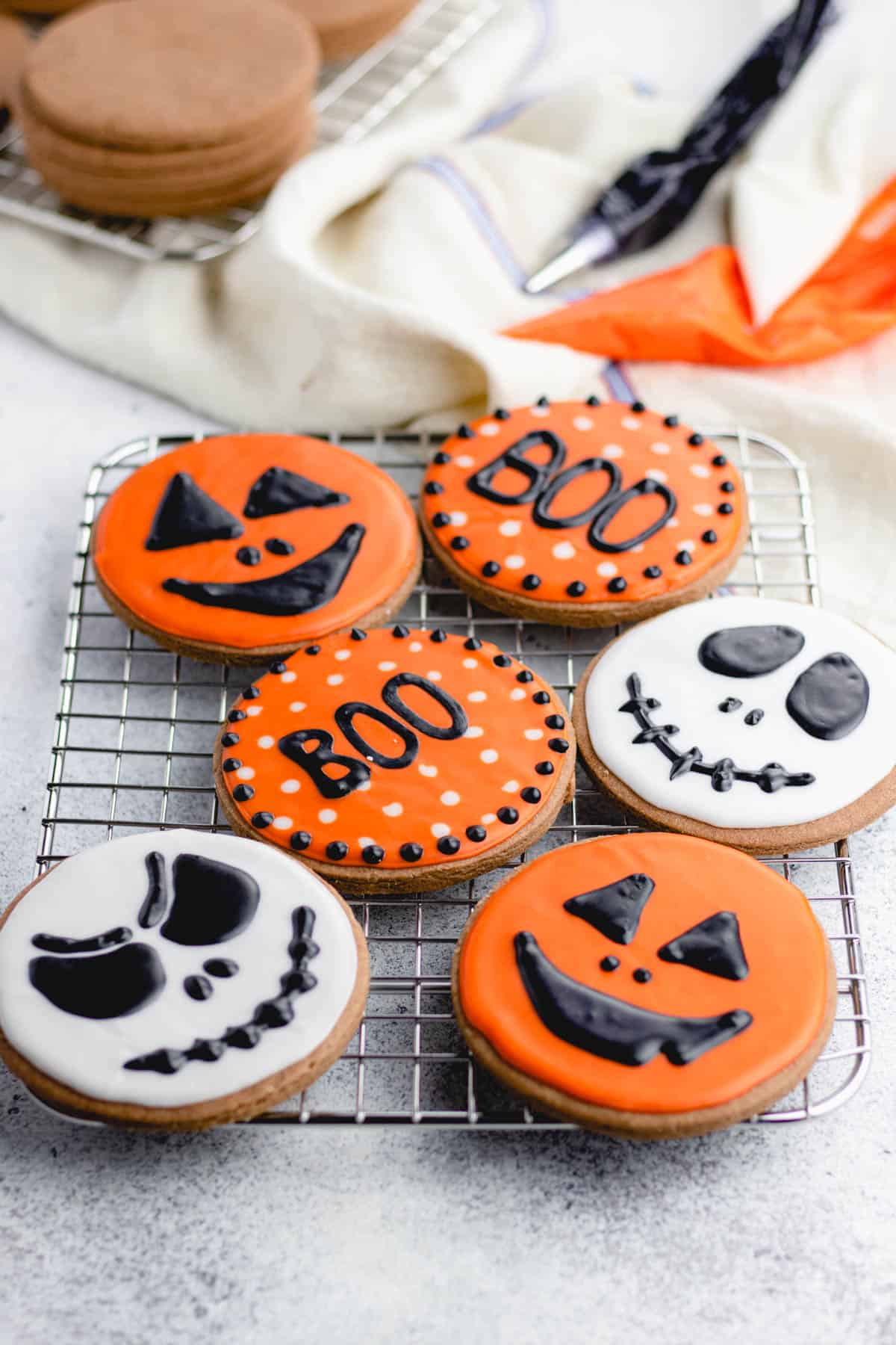 Cut out cookies, decorated with white, black, and orange halloween theme.