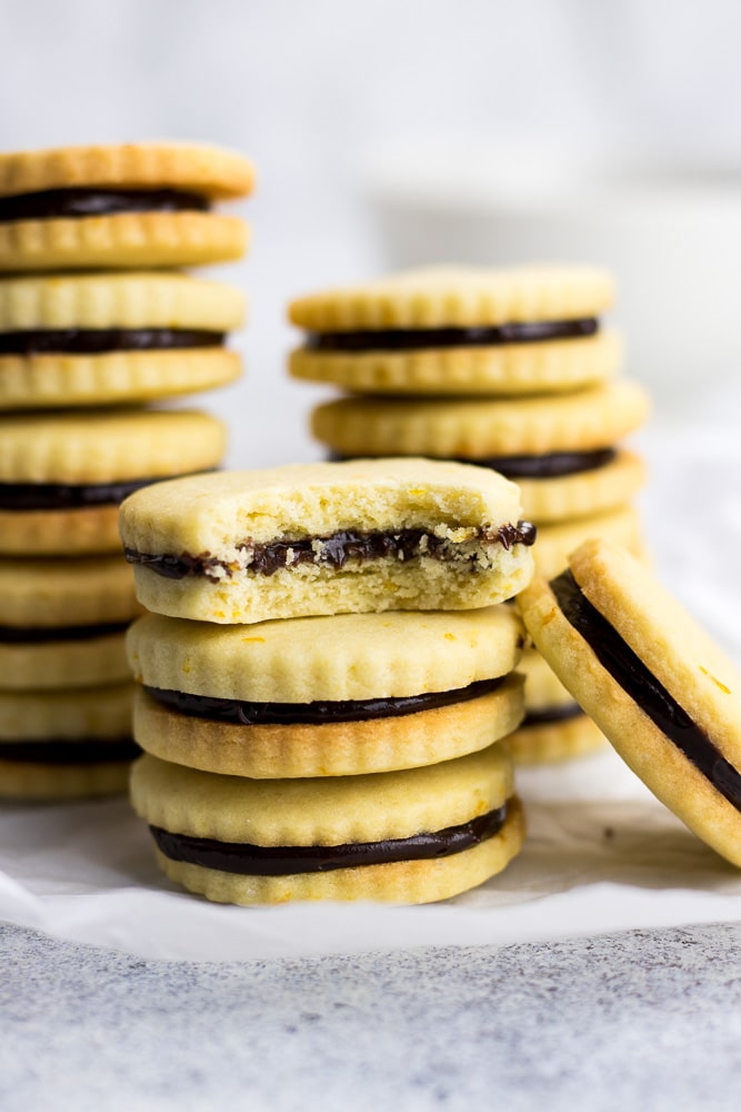 Orange Chocolate Sandwich Cookies are made with orange sugar cookies and filled with chocolate ganache. This is the best cookies recipe for Christmas and the holiday season!