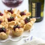 3 Ingredient Cranberry Bites is an easy appetizer for a party. Made with Puff Pastry, Brie Cheese, and Cranberry Sauce, this lovely starter will be perfect for the Holiday Season!