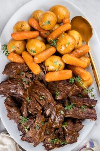 Pot Roast with Potatoes and Carrots on a white serving plate