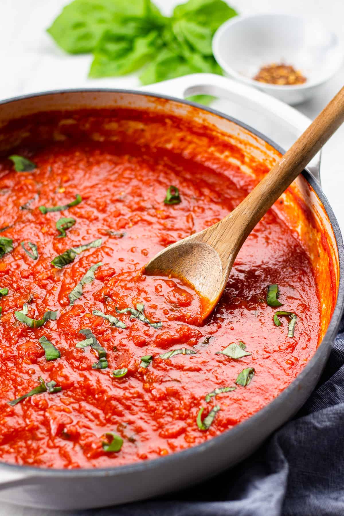 Marinara sauce in a white casserole pan.