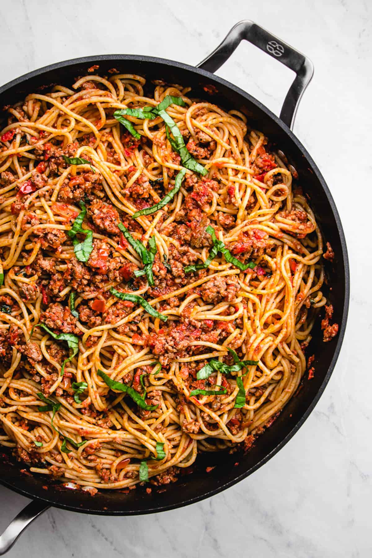 pasta with meat sauce in a skillet.