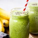 A close up photo of a green smoothie in a Mason jar.