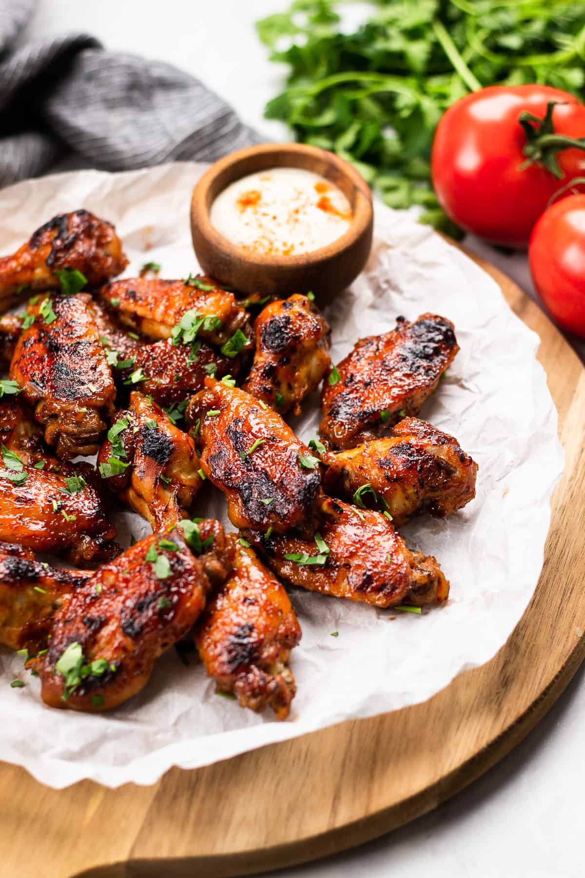 BBQ chicken wings on a serving board.