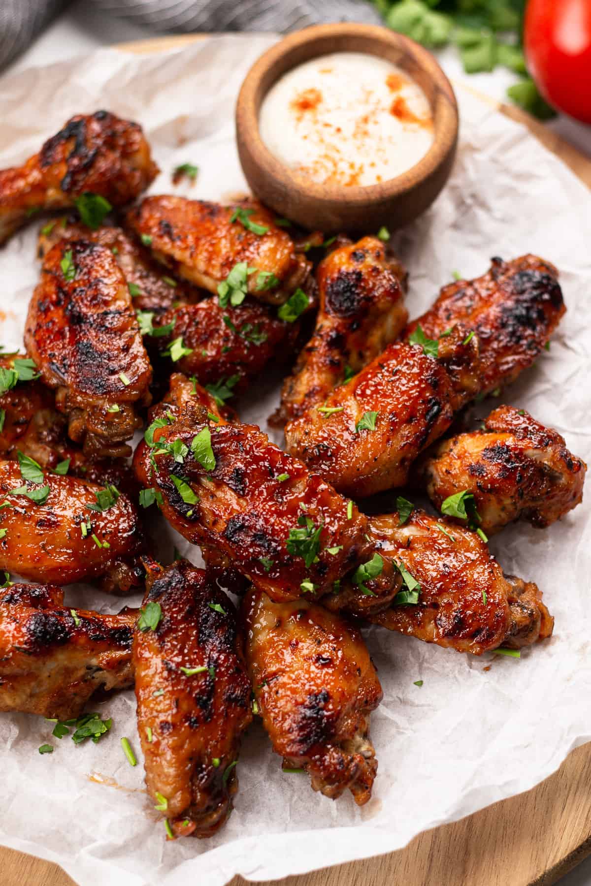 BBQ chicken wings on a serving board.