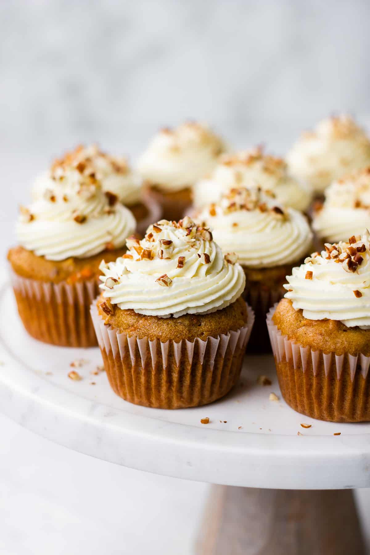 Carrot Cake Cupcakes topped with Cream Cheese Frosting on a serving platter.