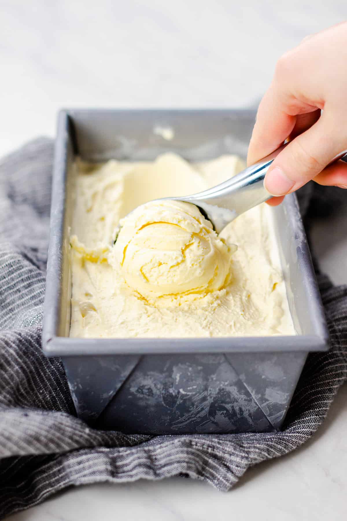 Scooping ice cream from a container.