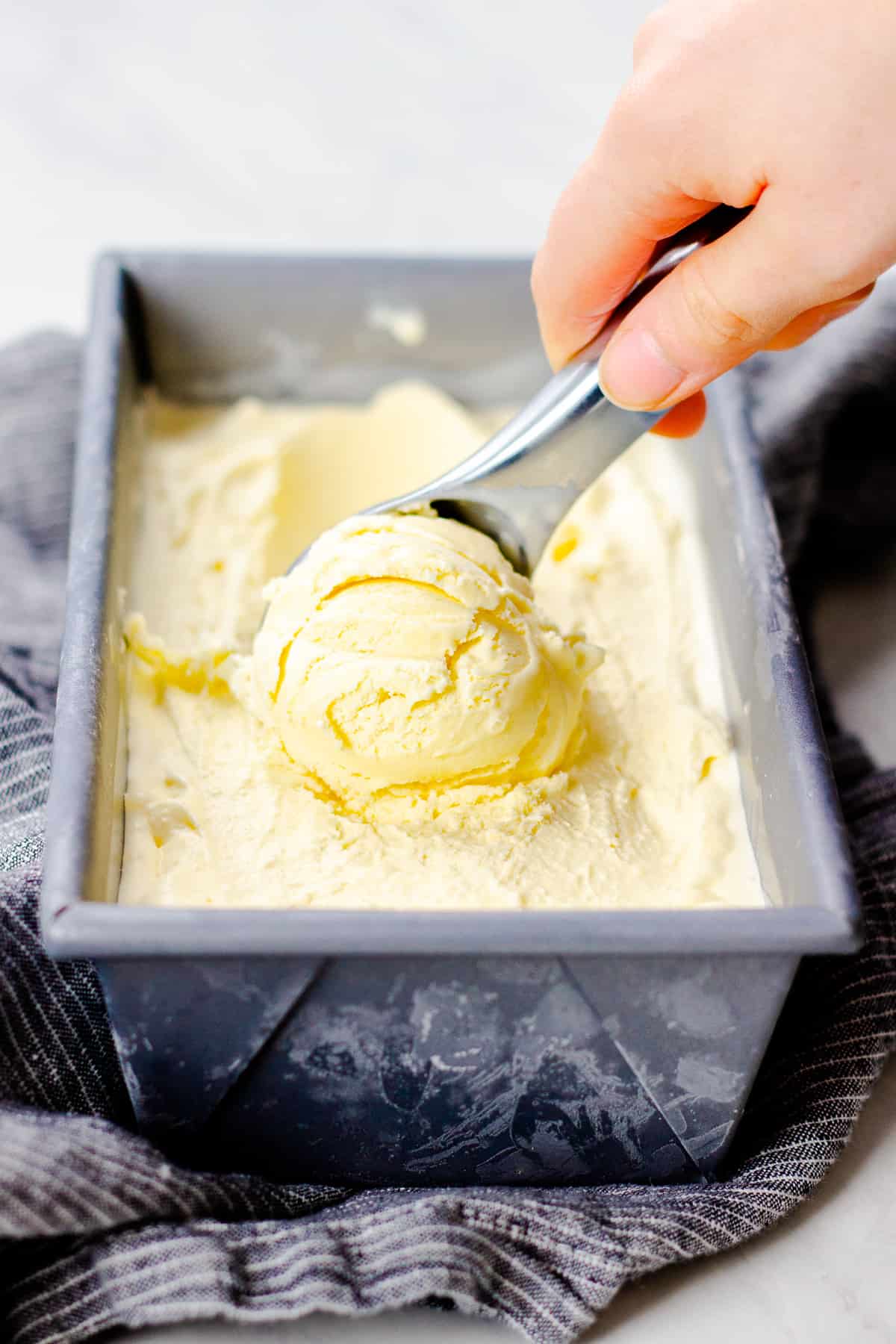 Scooping ice cream from a container.