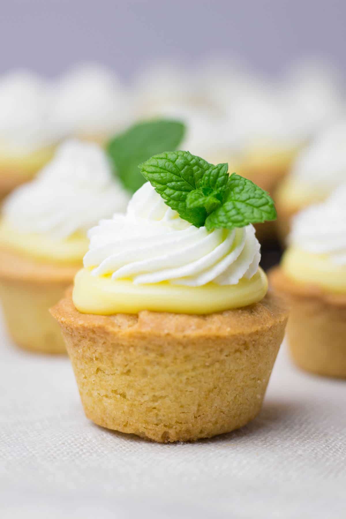 Cookie cups filled with lemon curd and whipped cream.