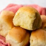Dinner rolls on a red kitchen towel.