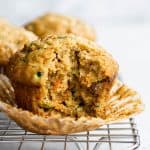 Freshly baked Carrot Zucchini Muffins on a wire rack.
