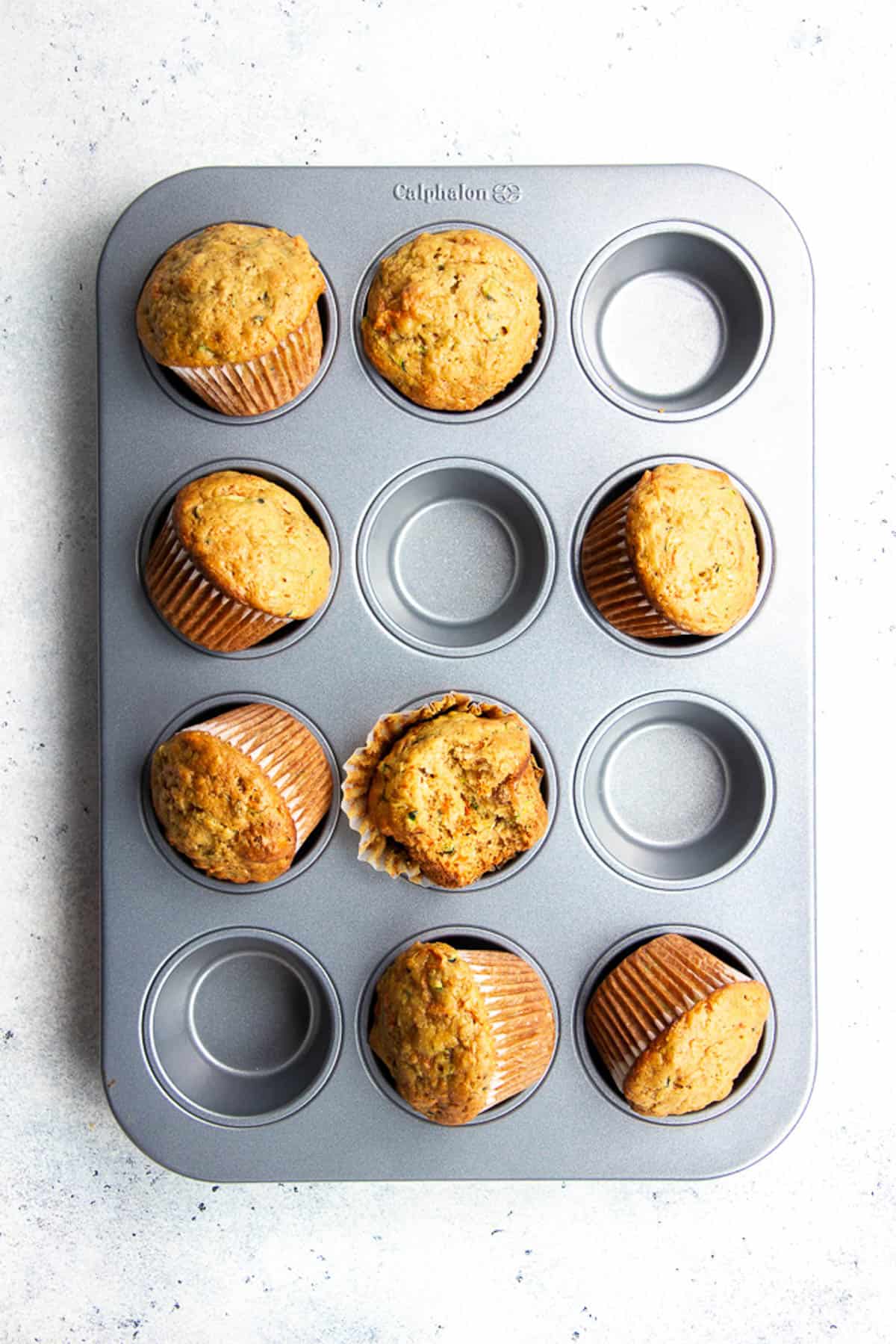 Freshly baked Carrot Zucchini Muffins in a muffin tin.