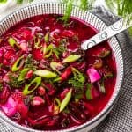 Beet Soup topped with green onions on a bowl.