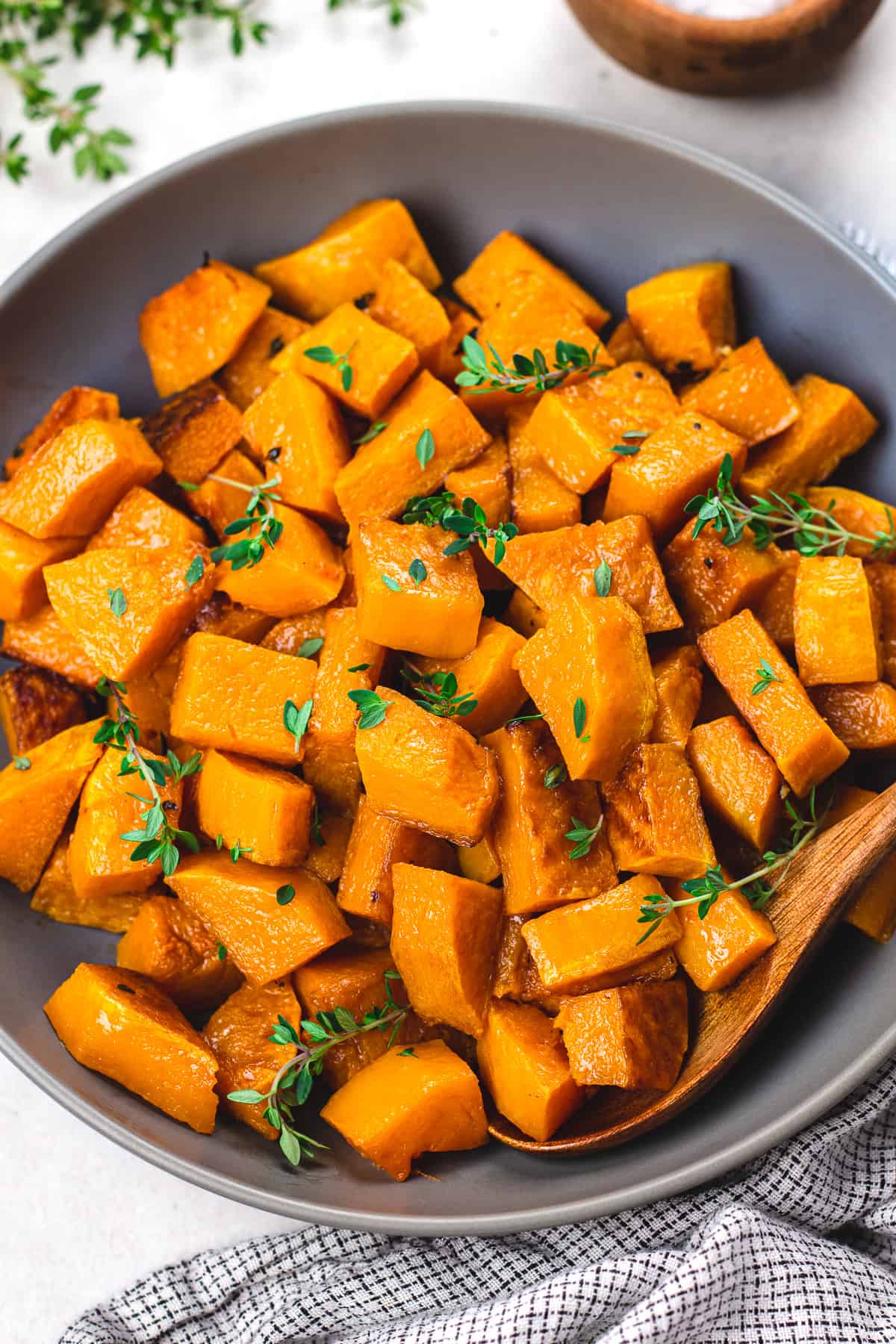 Roasted butternut squash in a dark grey bowl.