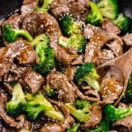 Beef and Broccoli in a skillet, topped with sesame seeds.