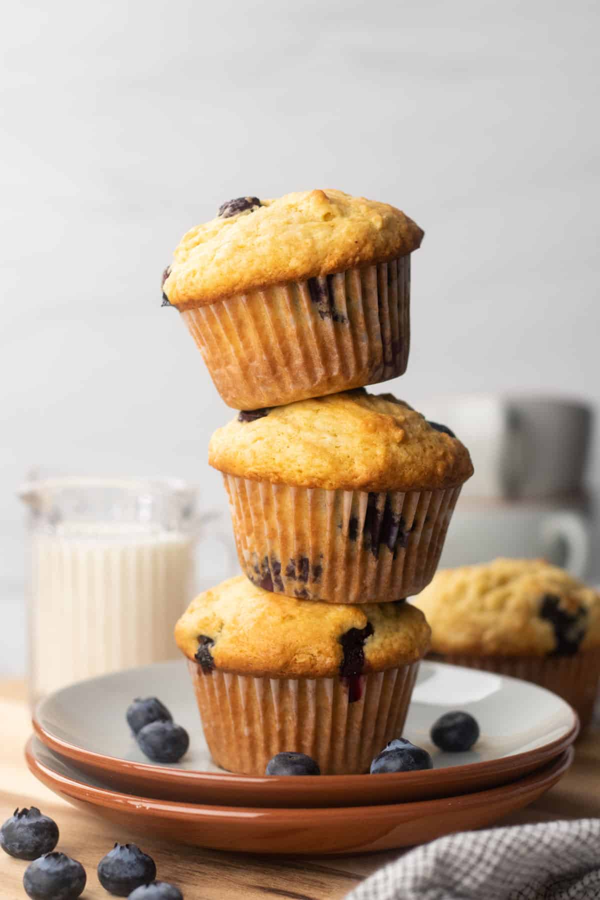 Three Blueberry muffins on top of each other.