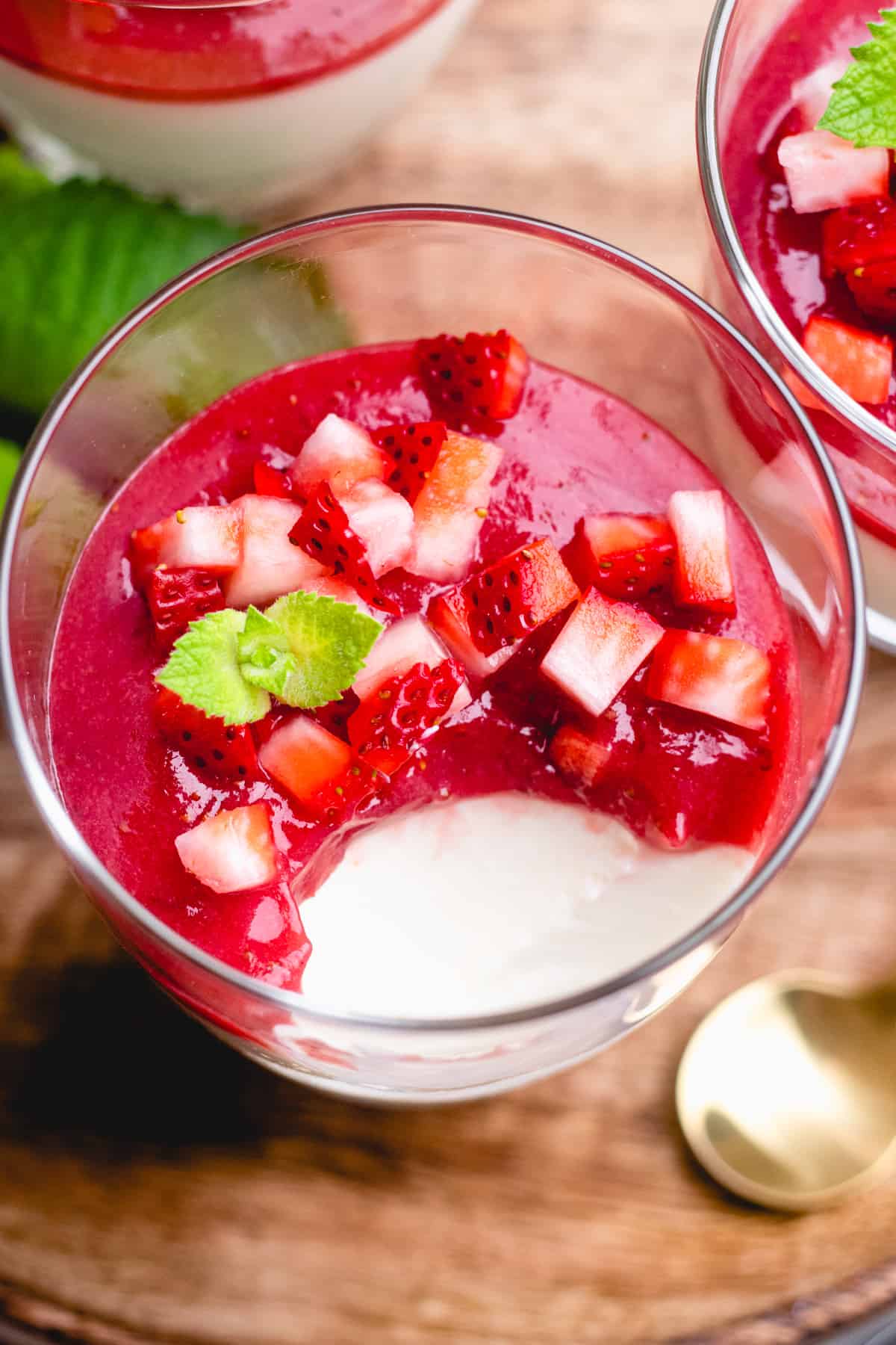 Panna cotta with strawberry sauce and fresh berries in a glass.