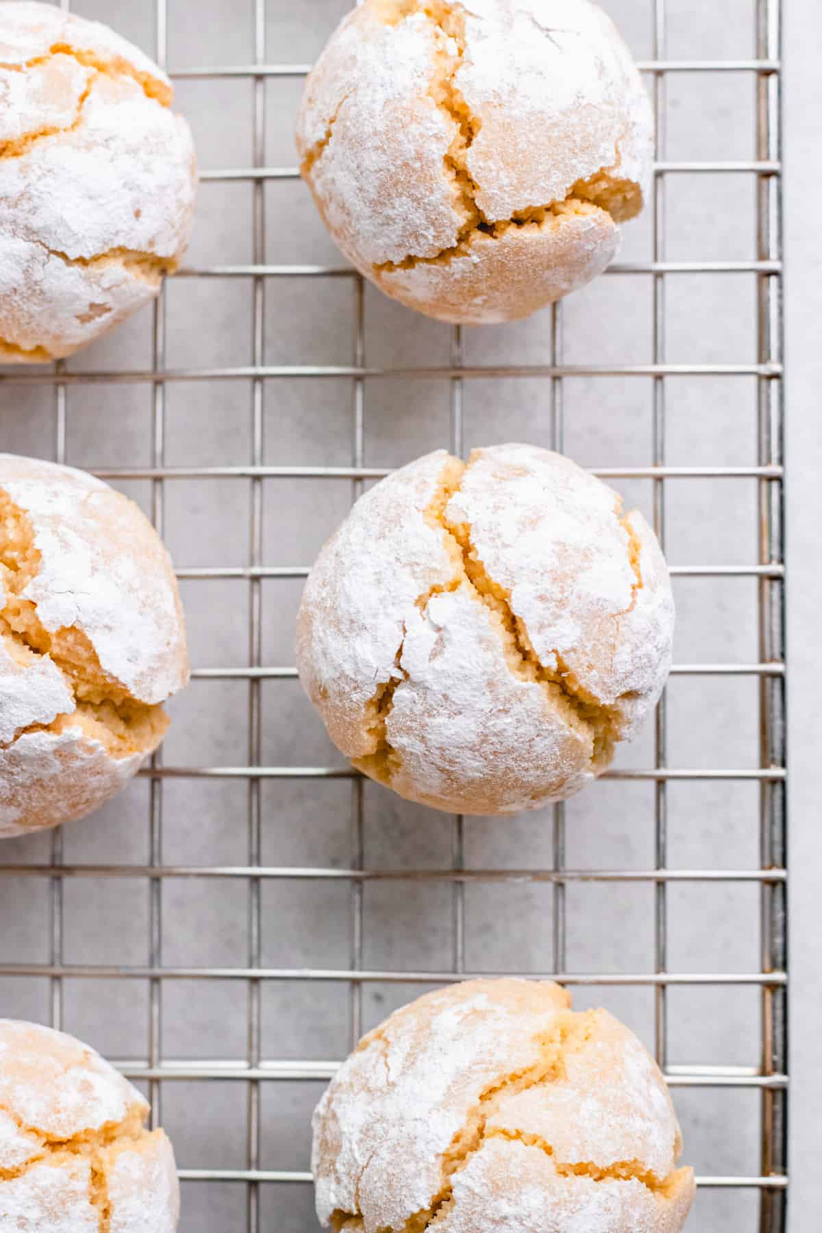 Crinkled amaretti cookies on a wire rack.