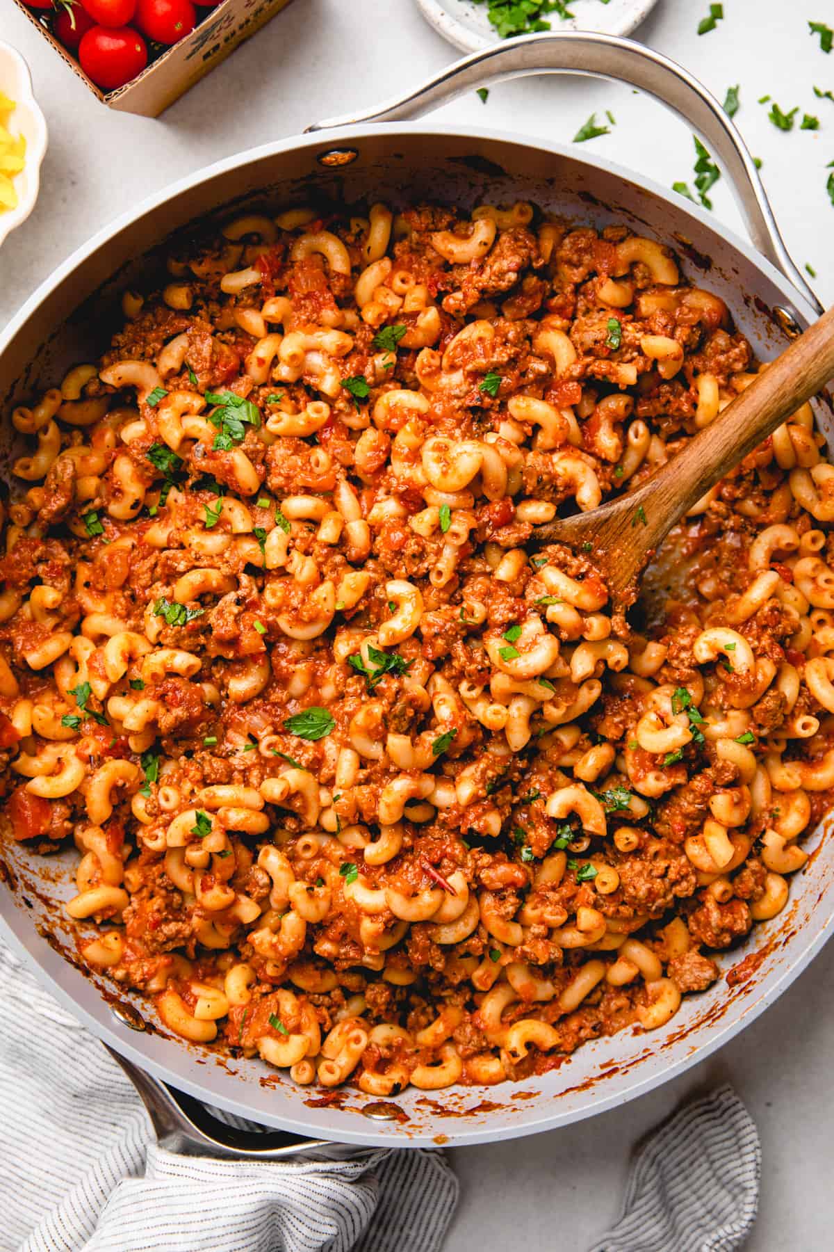 Old Fasioned American Goulash, made with round beef, tomato sauce, and elbow macaroni, topped with chopped parsley.