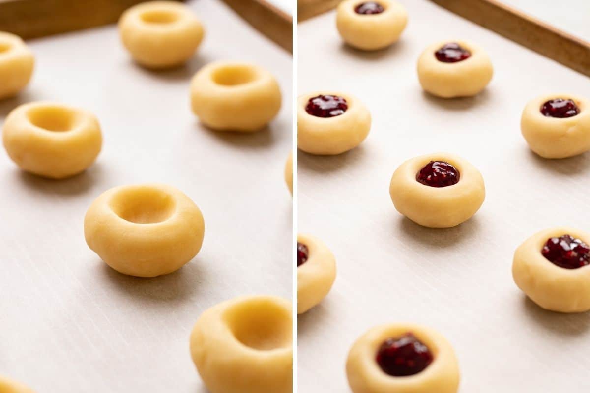 Shaped thumbprint cookies, filled with raspberry jam on a baking sheet with parchment paper.