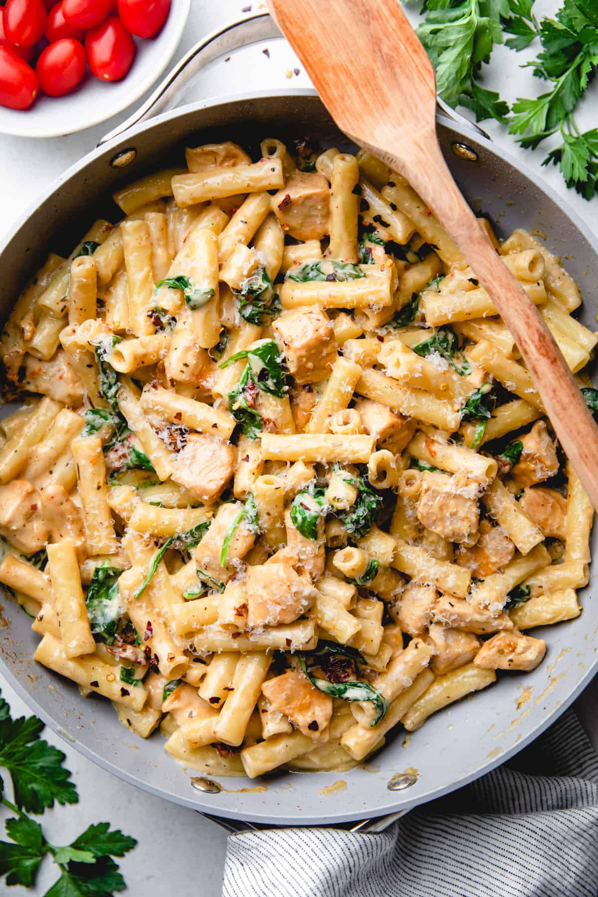 Pasta with chicken, sun dried tomatoes, and spinach in creamy sauce.
