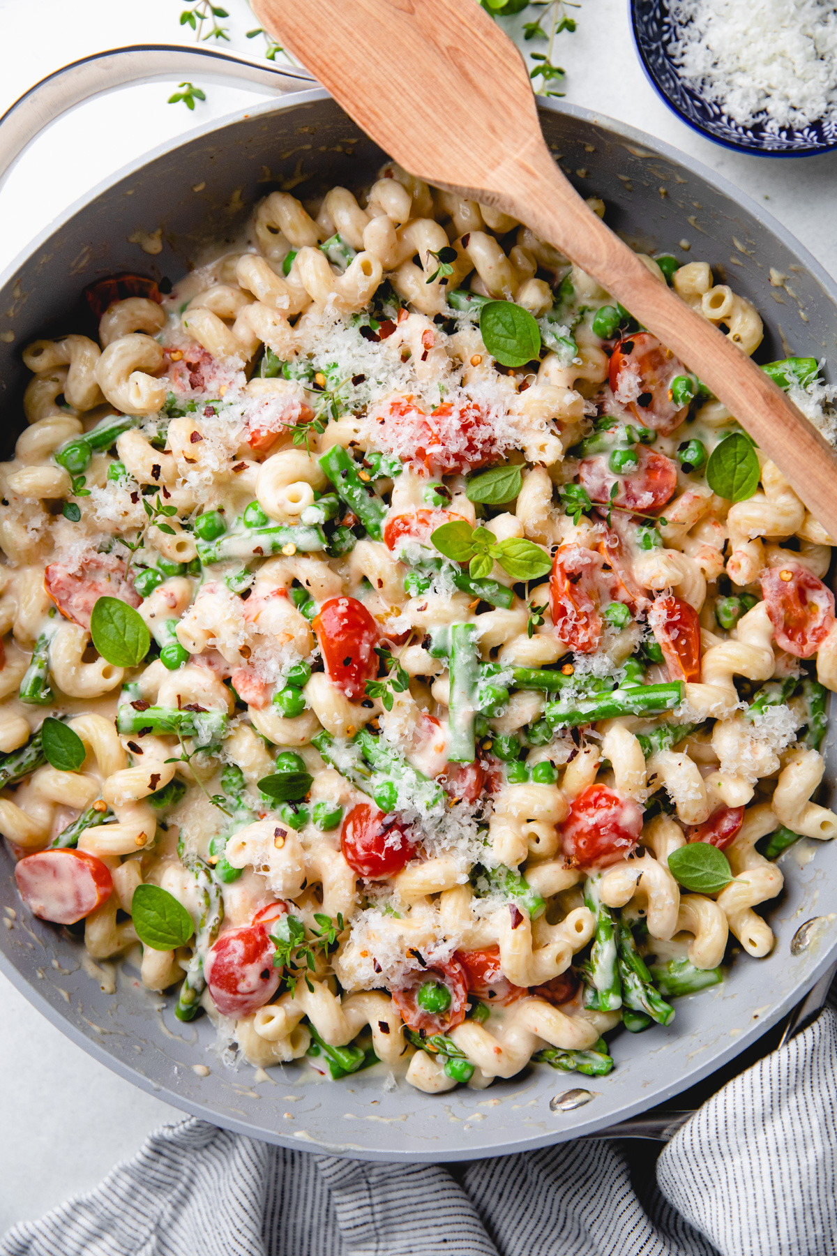 Pasta with cherry tomatoes, asparagus, peas, and creamy sauce.