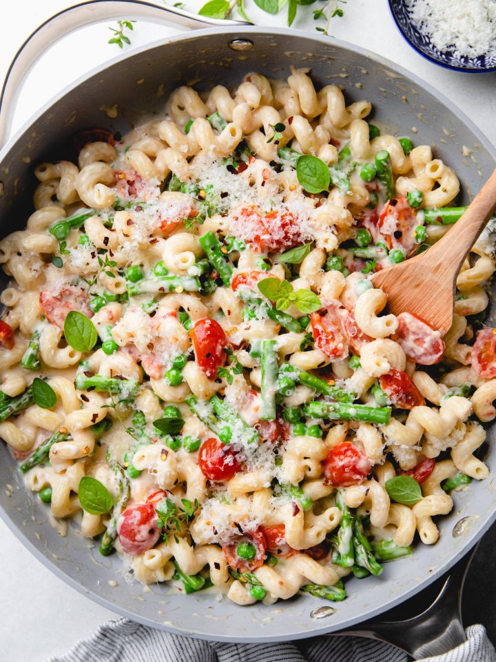 Pasta with cherry tomatoes, asparagus, peas, and creamy sauce.