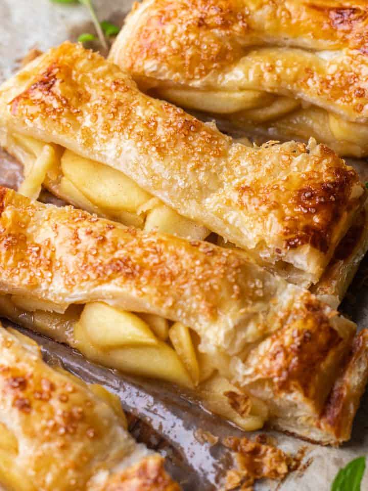 Sliced puf pastry pie, filled with caramelized apple slices.