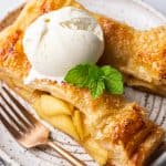 Two slices of Apple Pie with Puff Pastry with a scoop of ice cream on top.