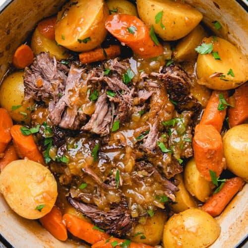 Pot Roast with carrots and potatoes in a Dutch Oven.