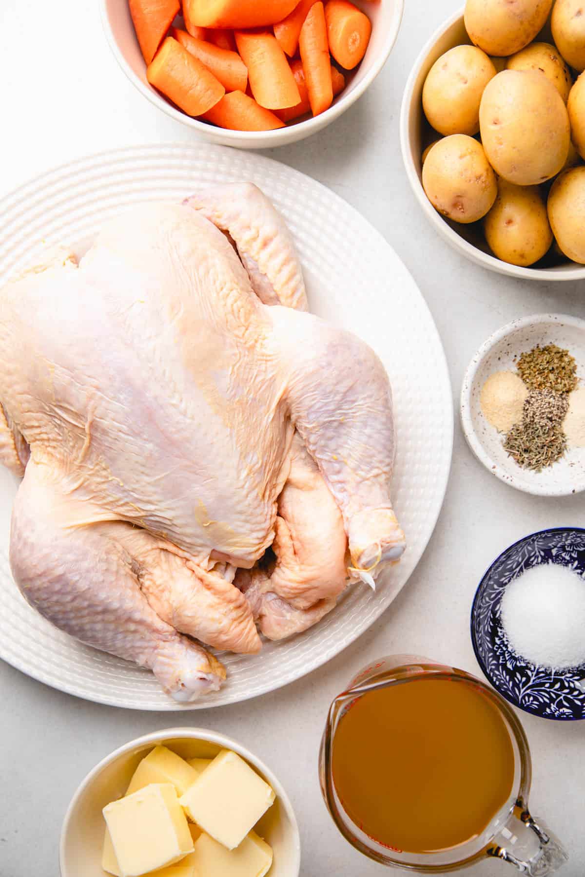Ingredients to make whole roasted chicken with vegetables.