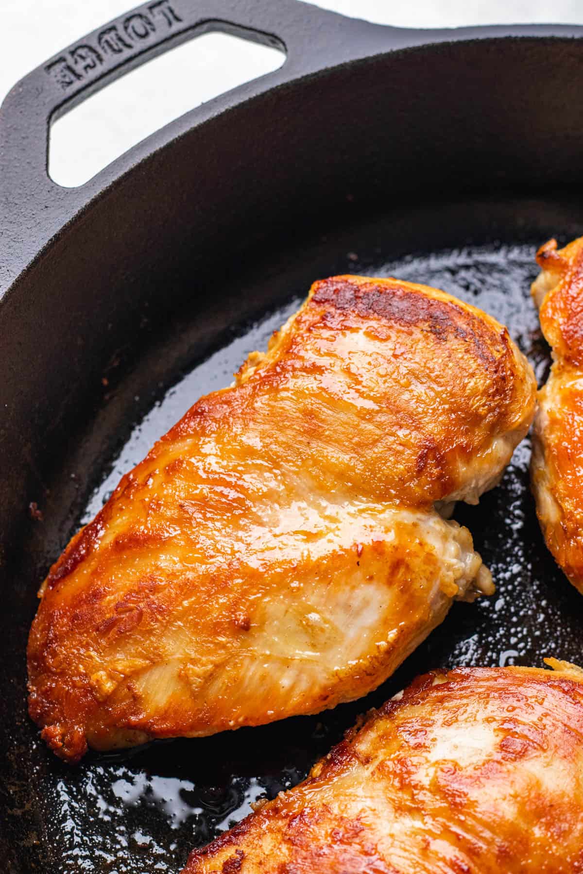 Seared chicken breasts in an cast iron skillet.