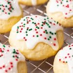 Sour Cream Cookies, topped with sugar icing and sprinkles on a wire rack.