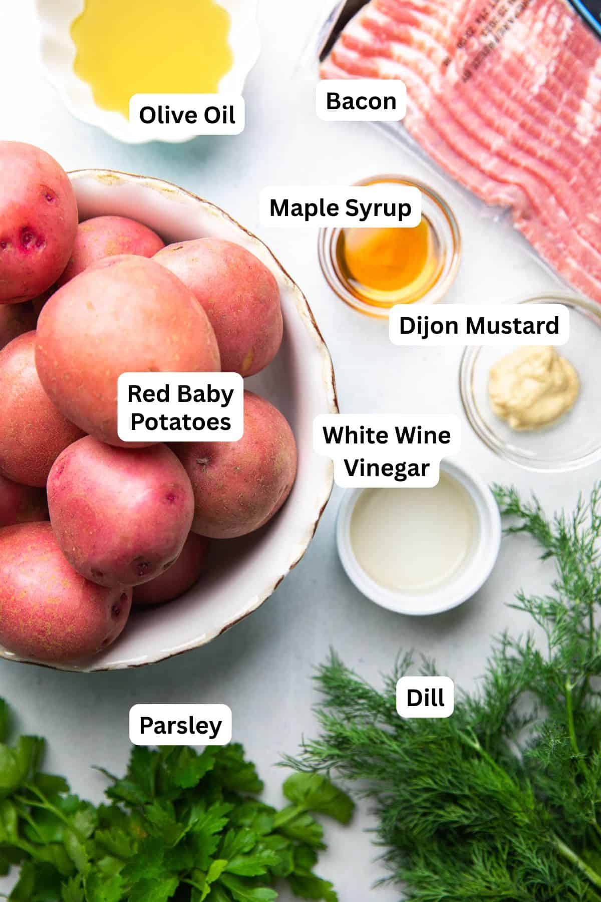 Separate ingredients to make red potato salad with dill.