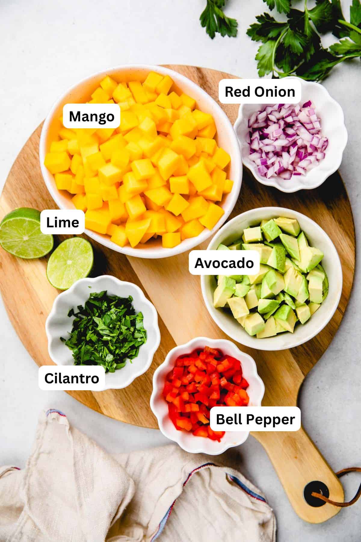 Chopped Ingredients for mango avocado salsa in separate bowls.