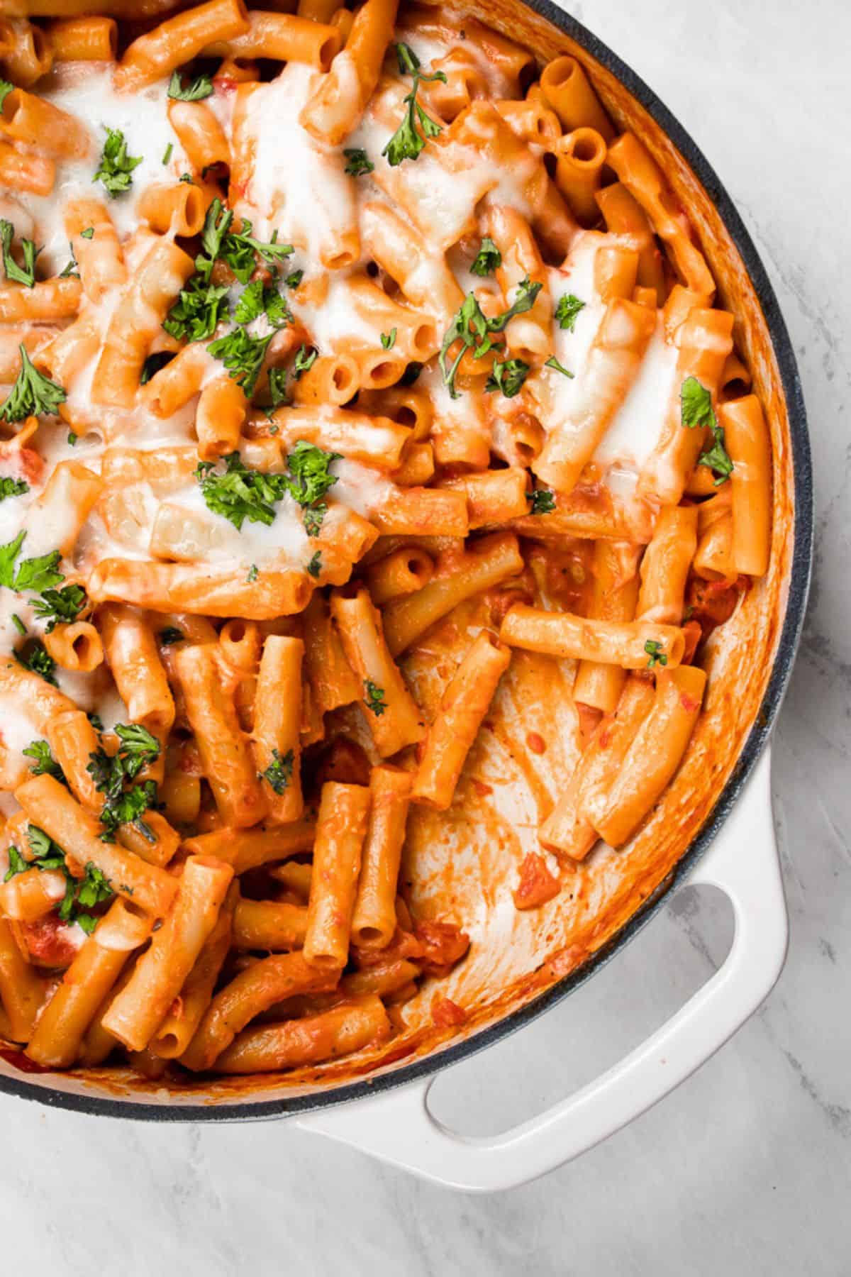 Cheesy baked ziti in a skillet.