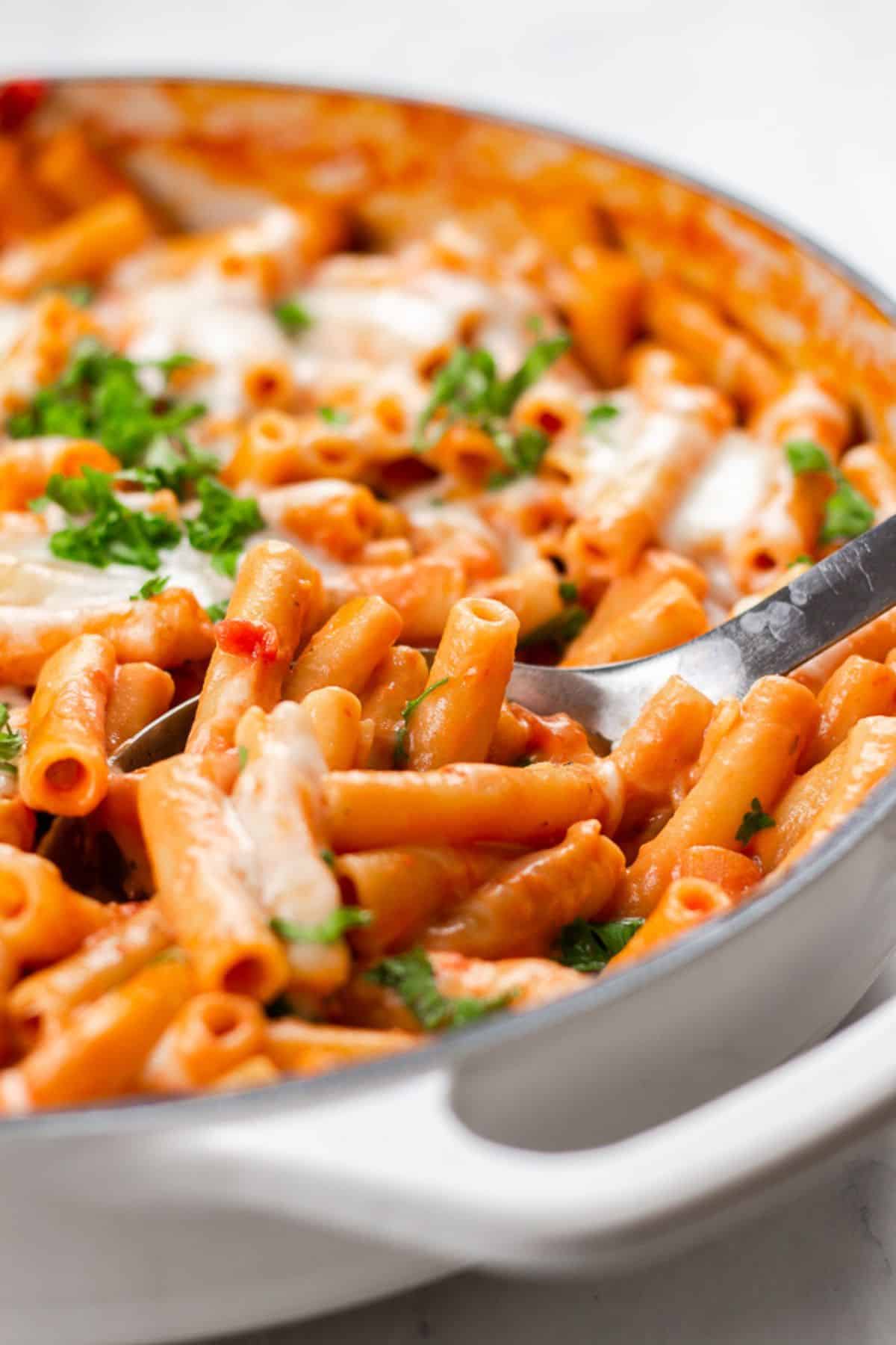 Cheesy baked ziti in a skillet.