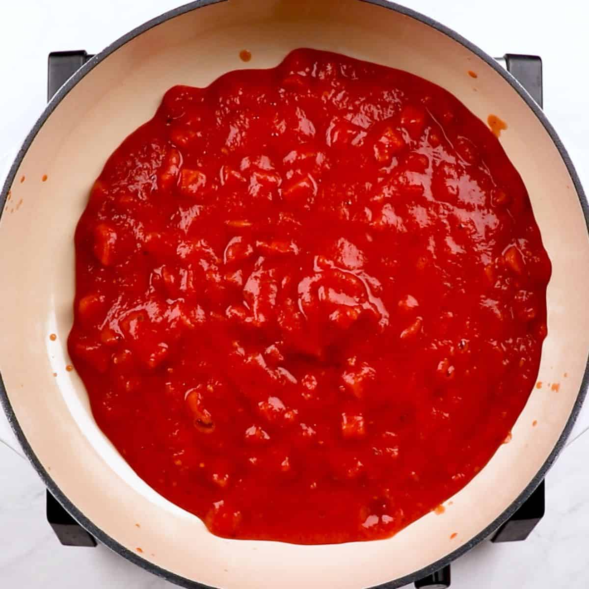 Crushed tomatoes in a skillet.